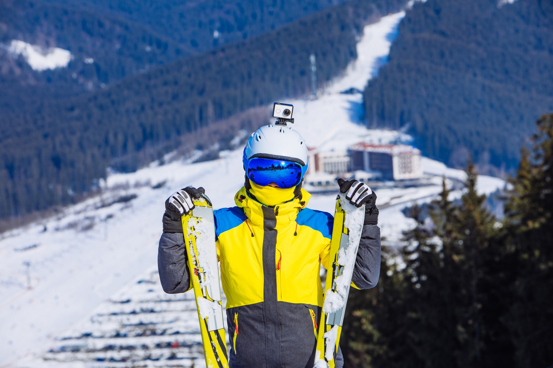 woman in ski equipment on the top of the hill